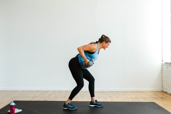 Woman performing a single arm dumbbell back row in a Dumbbell Arm Workout