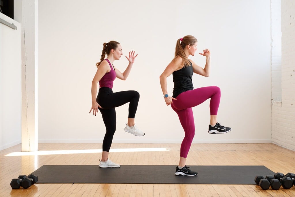 two women performing a lunge and knee drive in a superset leg workout