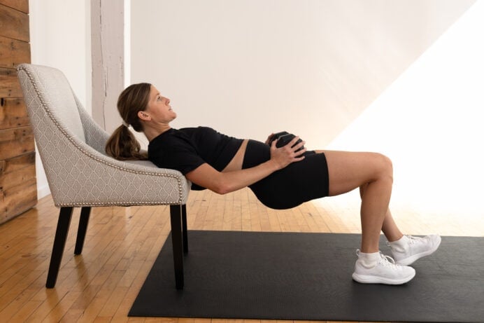 woman performing a staggered deadlift as part of hamstring workout